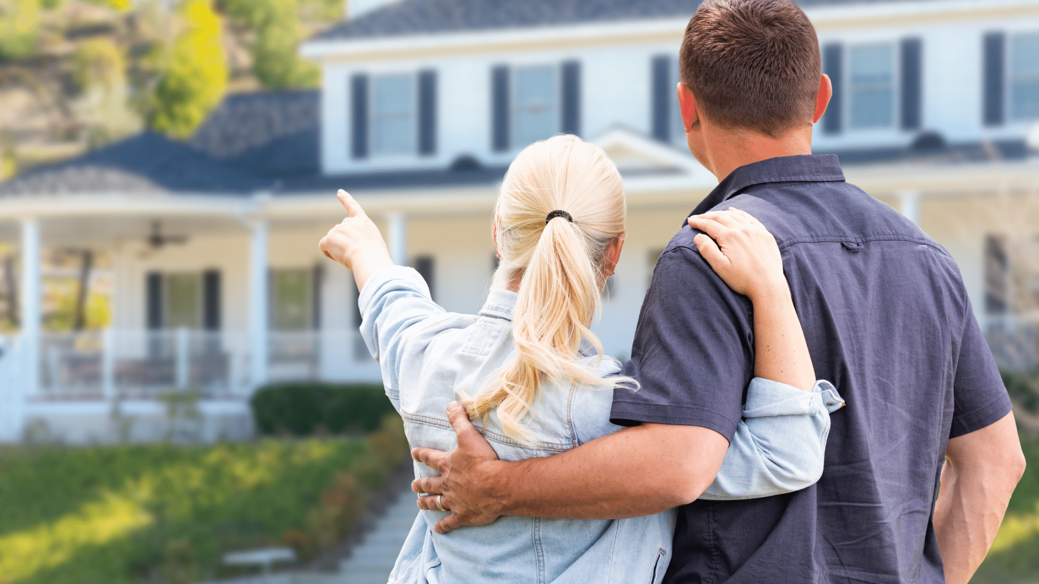 Smiling homeowners standing outside their upgraded California home with new living space